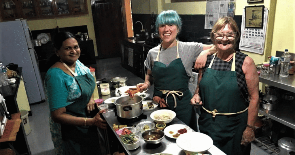 Women enjoying a cooking experience with a local host on a luxury India tour